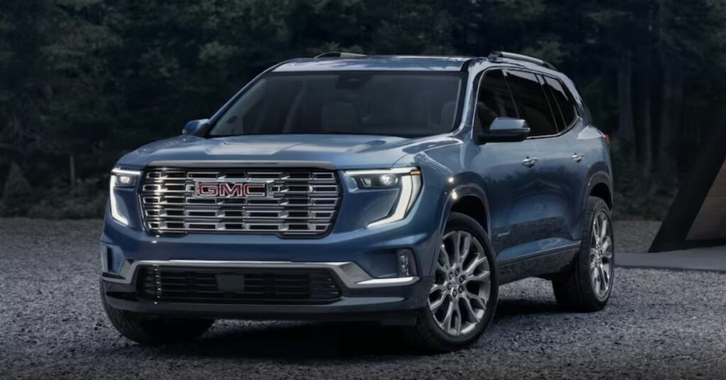 Elegant front view of the 2024 GMC Acadia showcasing its bold grille and headlights.