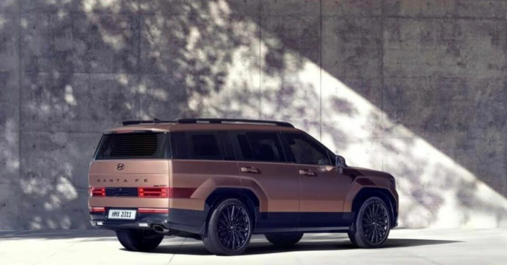 A brown SUV parked in a modern, concrete environment with sunlight casting shadows.