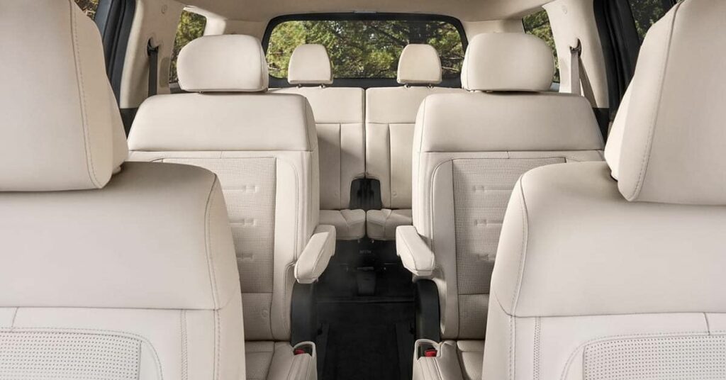 Interior view of a white leather three-row seating SUV.